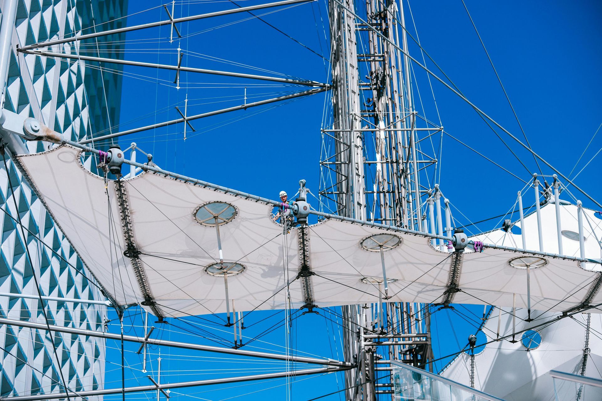 A large structure with a blue sky in the background is being built.