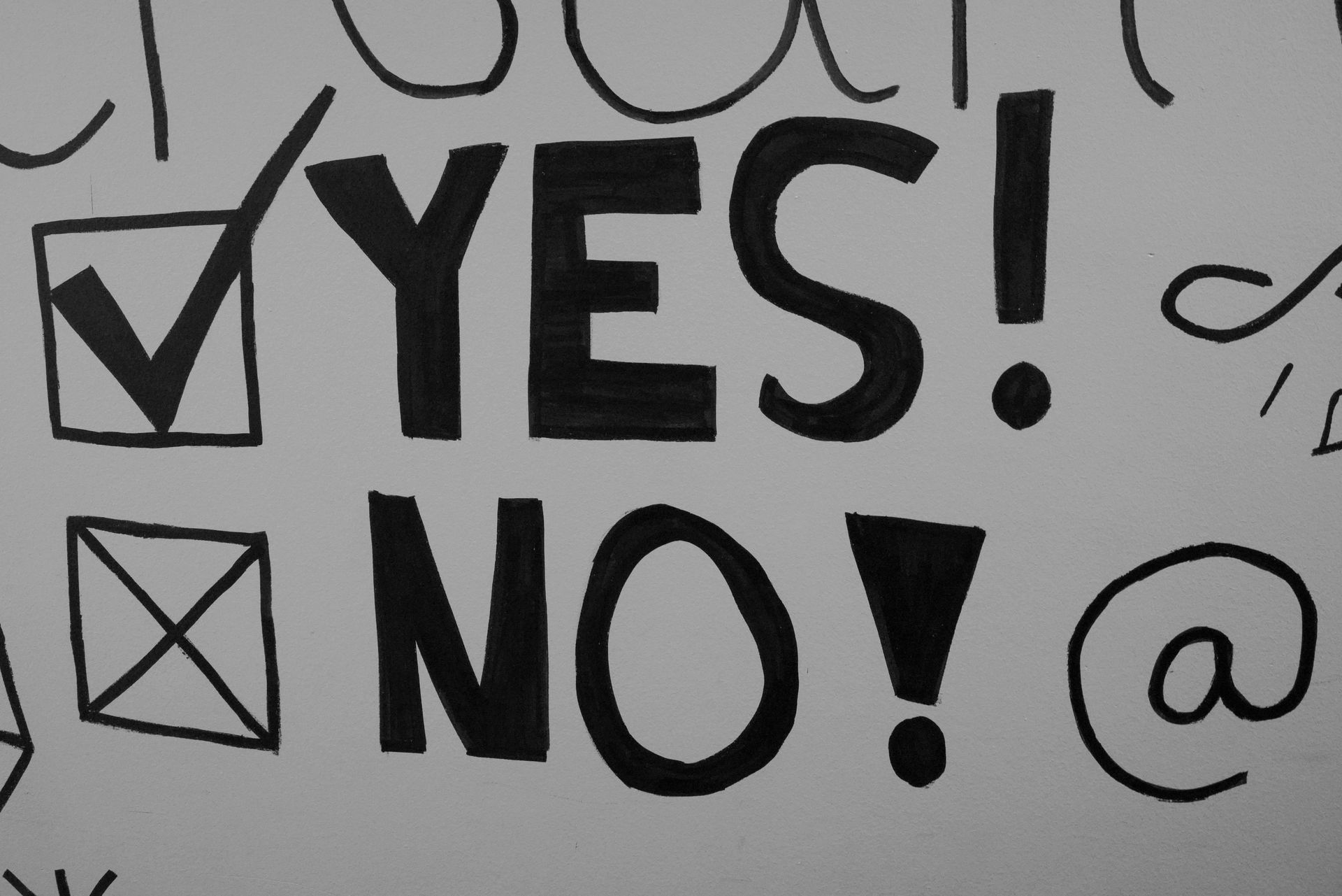a white board with yes ticked in black ink and no crossed out in black ink