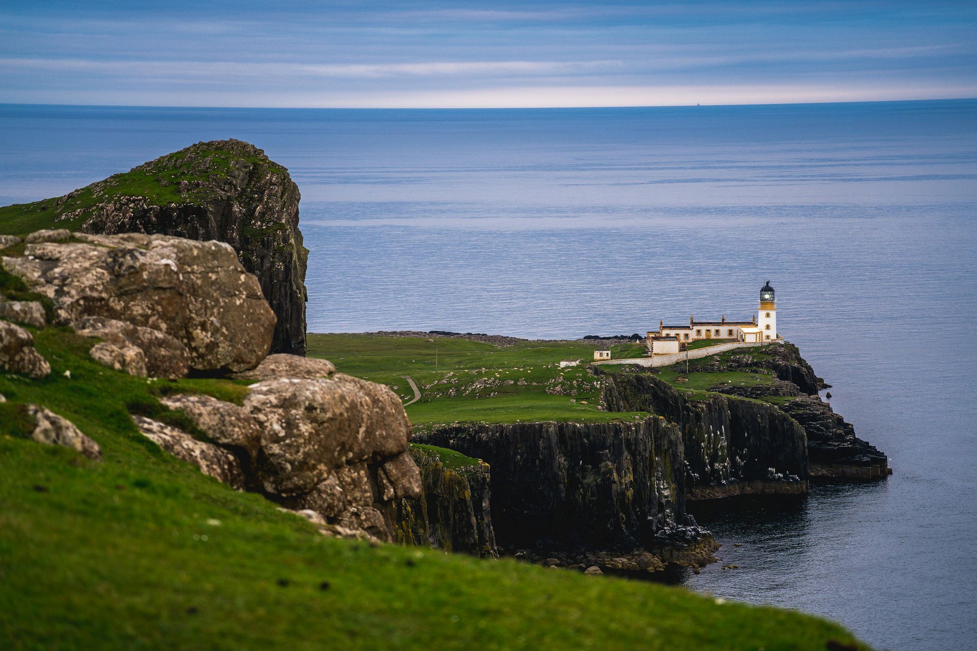 A lighthouse on top of a cliff overlooking the Irish sea