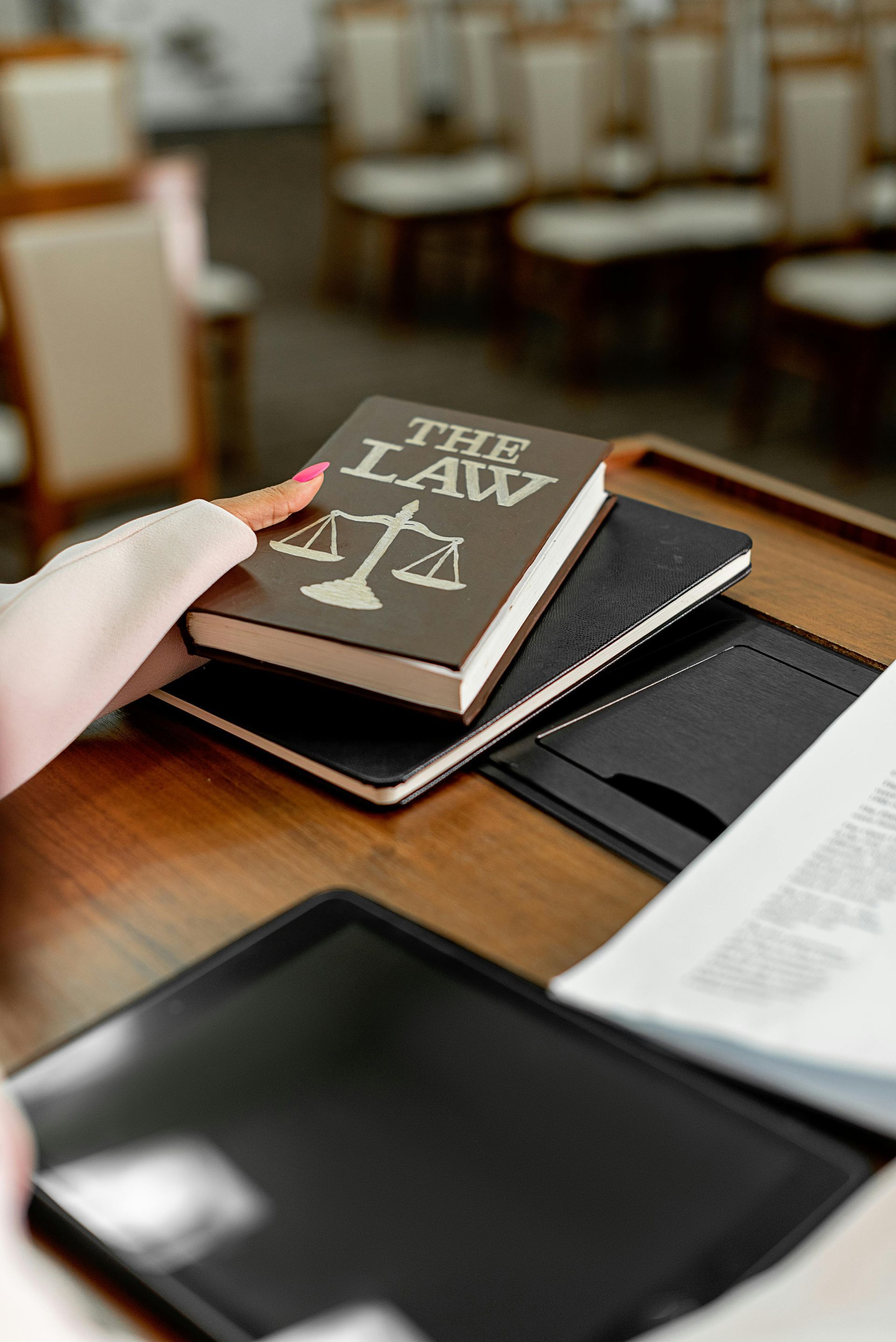 Person holding a book titled