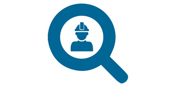 Magnifying glass with a person wearing a hard hat, related to construction and labor.