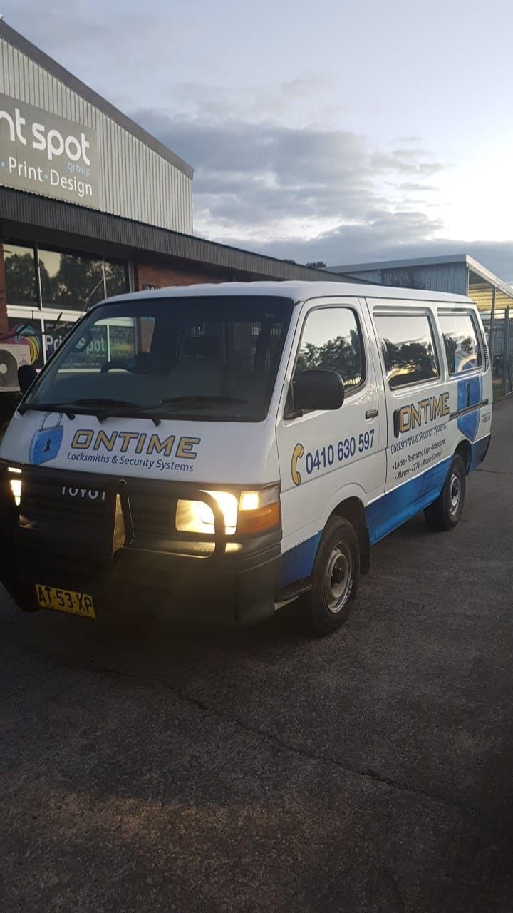 Van Having Helpline Number On It Parked In Front Of A Building — Ontime Locksmiths & Security In Mullumbimby, NSW