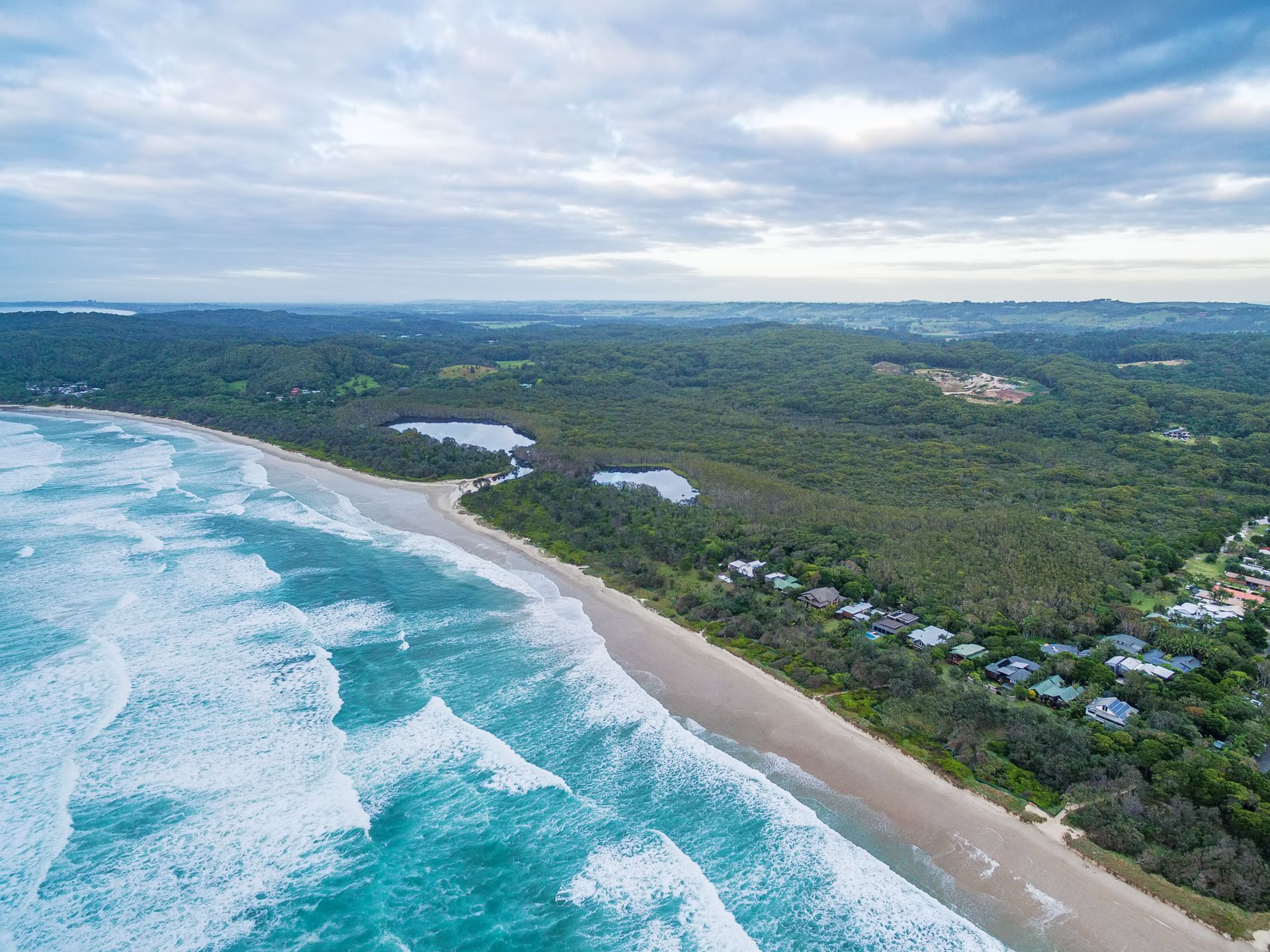 An Aerial View of a Beach With Waves Crashing on the Shore — Ontime Locksmiths & Security In Suffolk Park, NSW