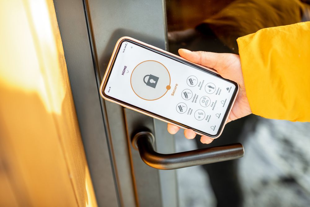 A Person is Using a Smart Phone to Open a Door — Ontime Locksmiths & Security In Mullumbimby, NSW