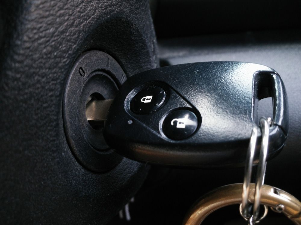 Car Key Having Two Buttons Is Plugged Into The Ignition Of A Car — Ontime Locksmiths & Security In Mullumbimby, NSW