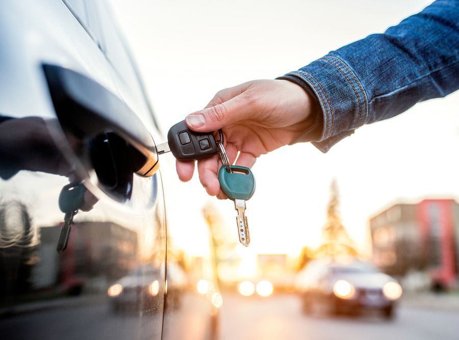 A Man Inserting A Car Key In The Car Door Lock — Ontime Locksmiths & Security In Byron Bay, NSW