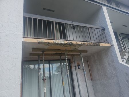 A building with a balcony that is being remodeled