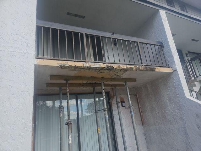 A building with a balcony that is being remodeled