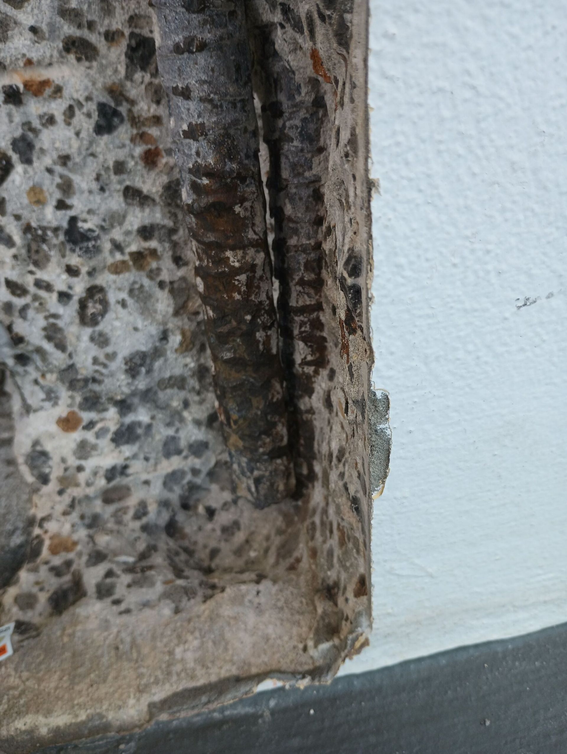 A close up of a concrete wall with a hole in it