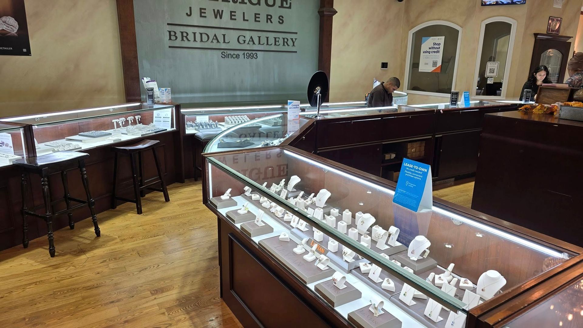 Inside a jewelry store with display cases filled with jewelry. The store sign reads 