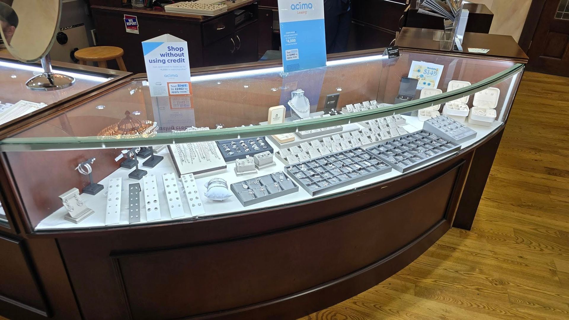 A jewelry display case filled with rings, necklaces, and other accessories in a well-lit store.