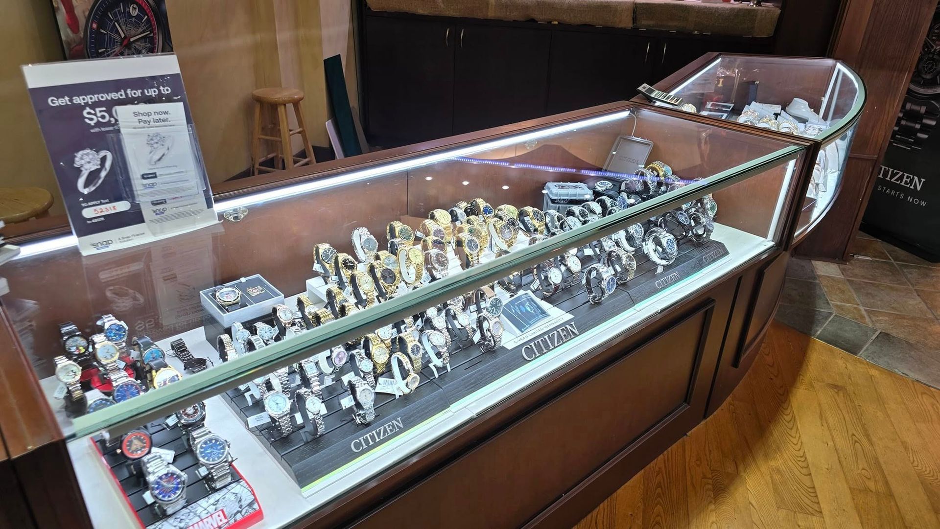 Display case in a jewelry store filled with watches of various styles and colors.
