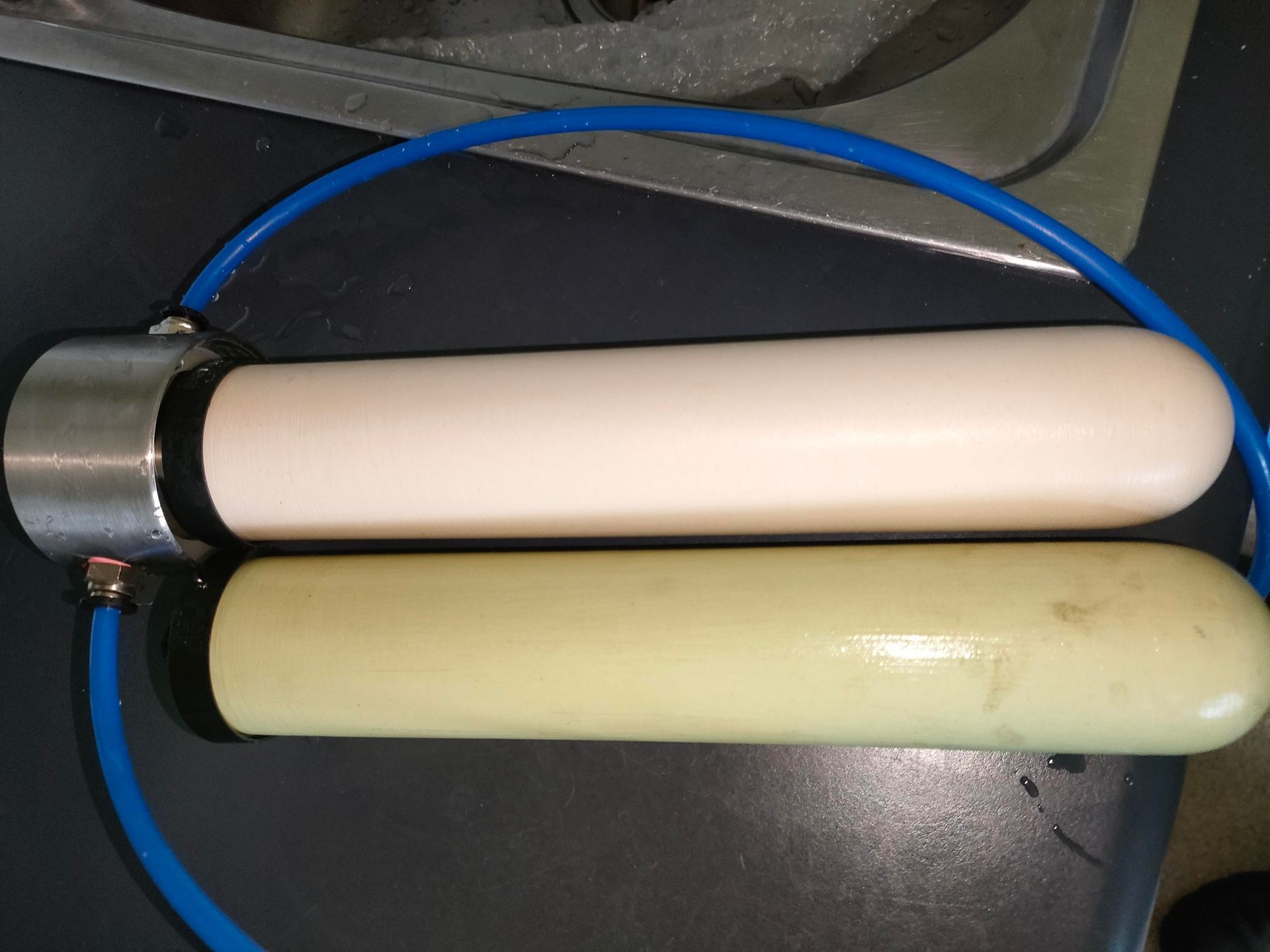 A Blue Water Filter Is Sitting On A Shelf Next To A Box — Cairns Clear Water Company In Cairns, QLD