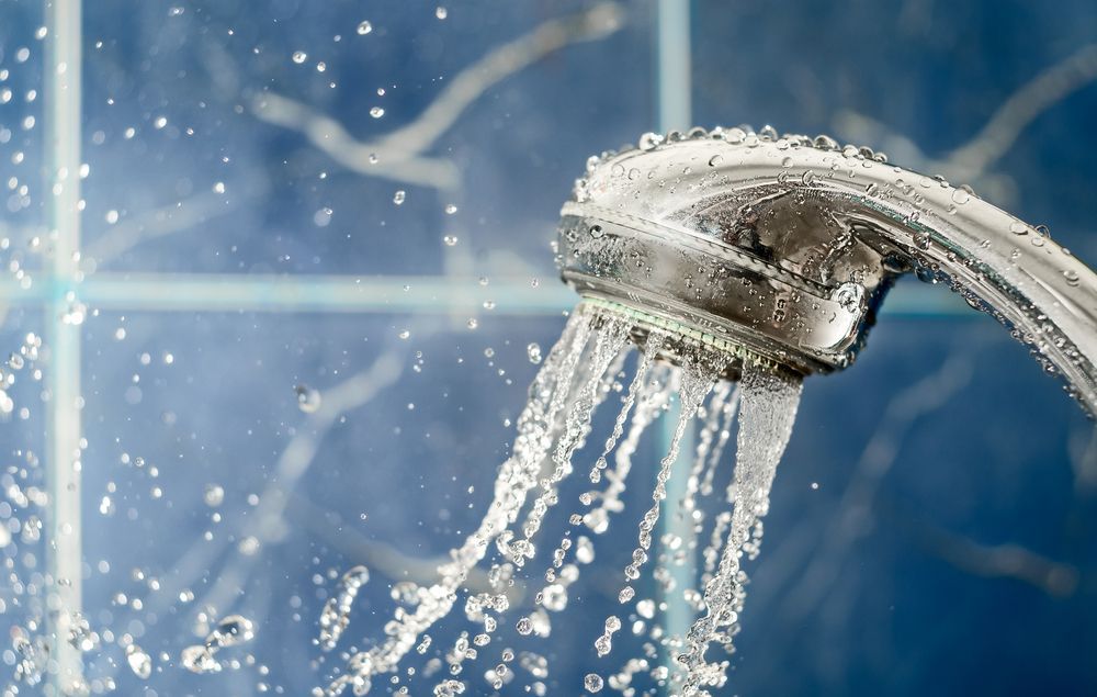 A Close Up Of A Shower Head With Water Coming Out Of It — Cairns Clear Water Company In Douglas Shire, QLD