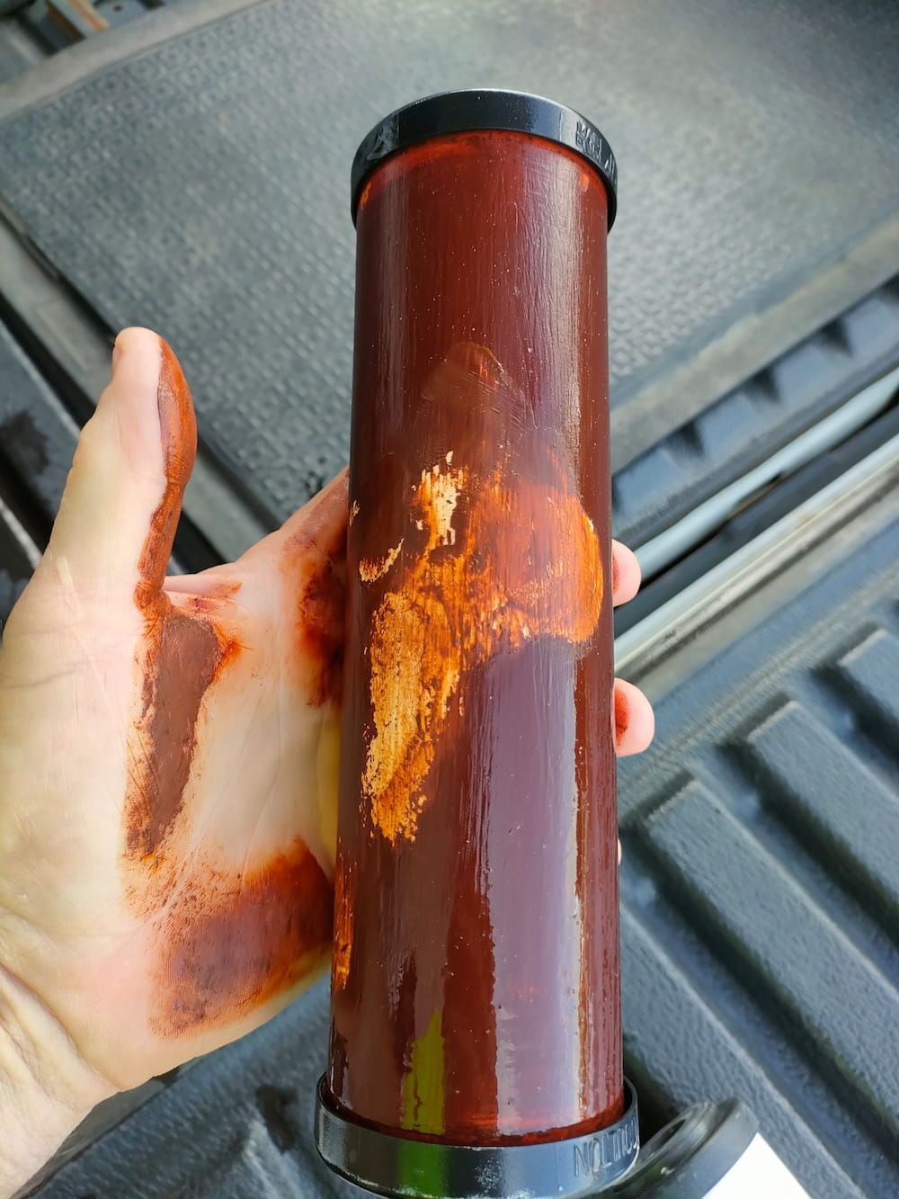 A Person Is Holding A Tube Of Red Liquid In Their Hand — Cairns Clear Water Company In Westcourt, QLD