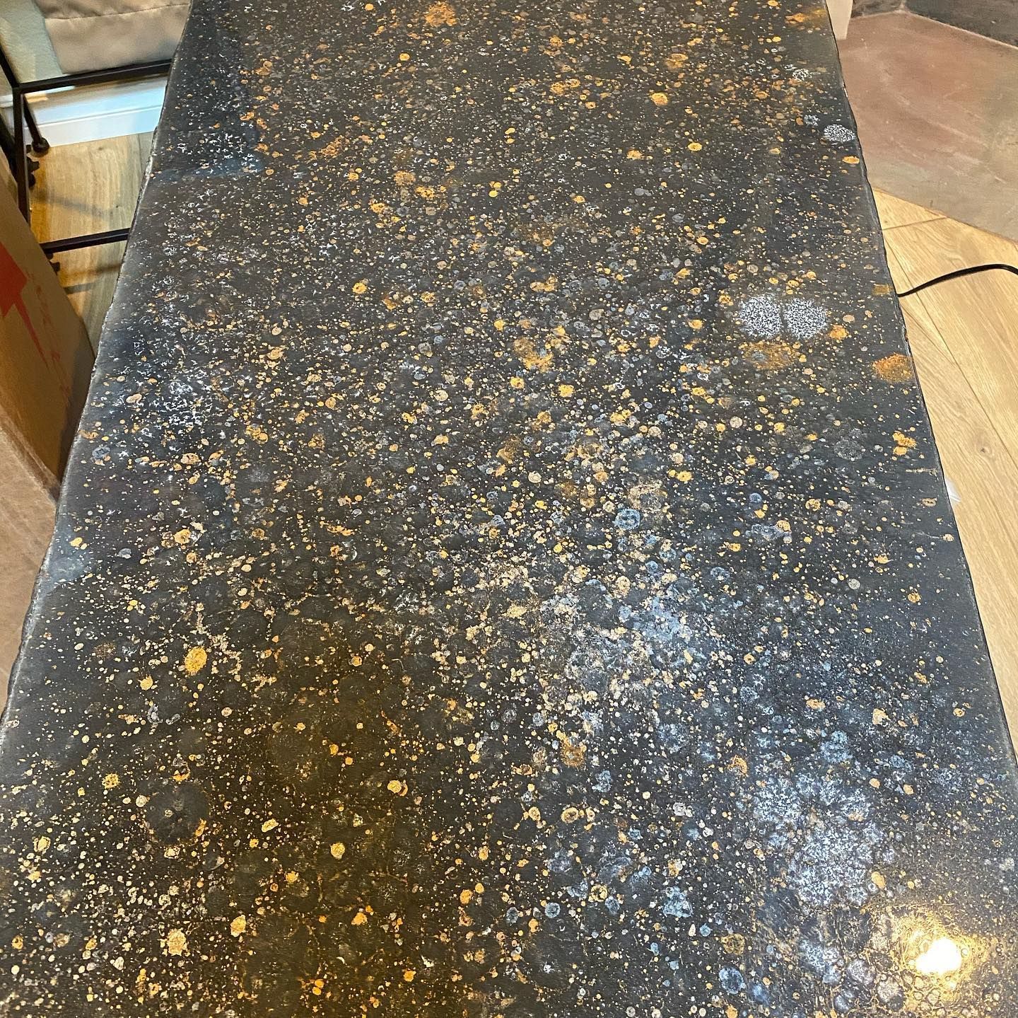 Elite Surface Coatings - Dark countertop speckled with gold and white flecks.