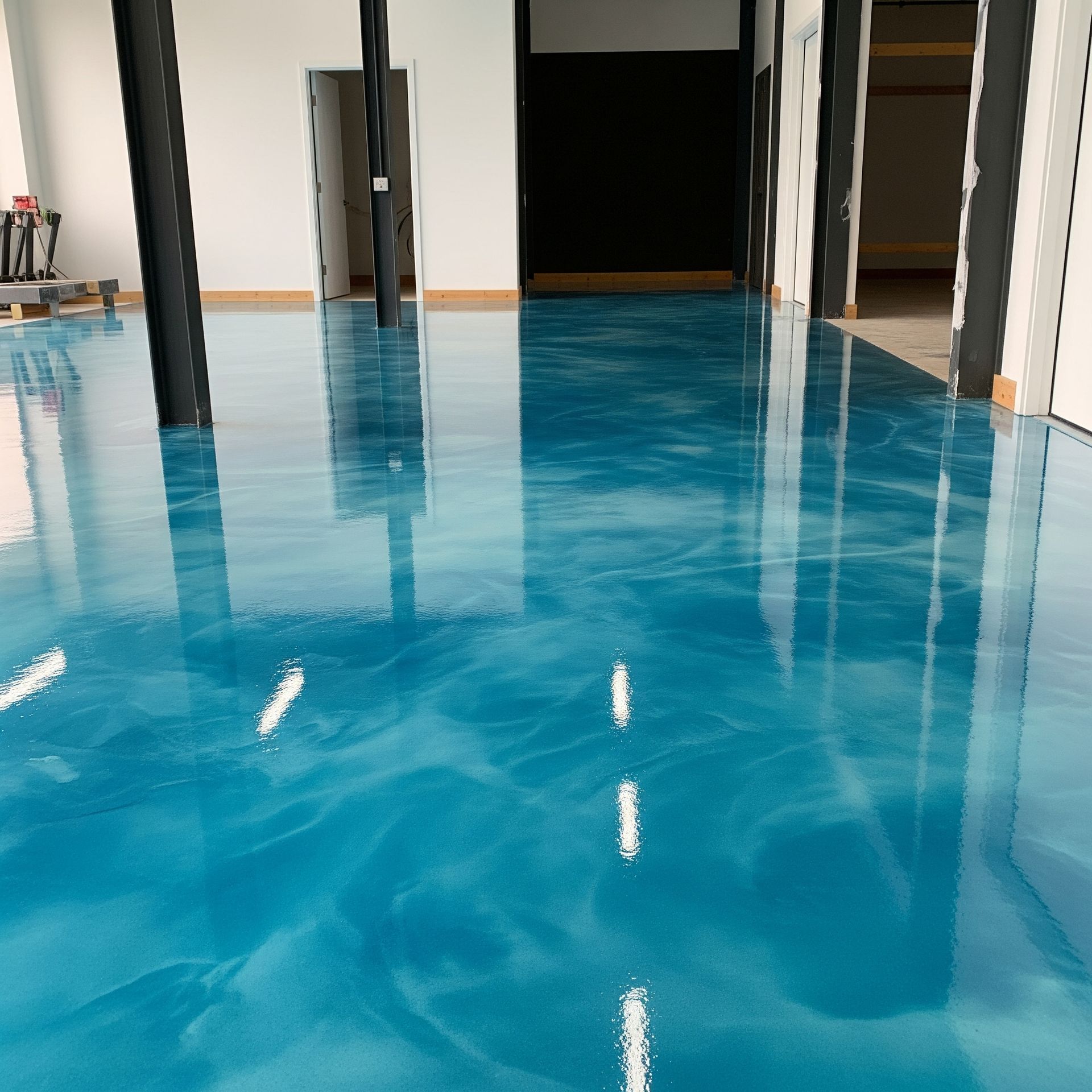 A large room with a blue floor that looks like a pool