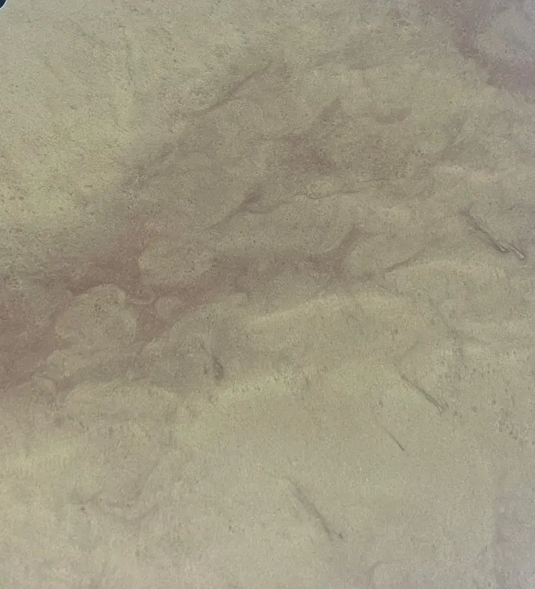 A close up of a piece of paper with a marble texture.