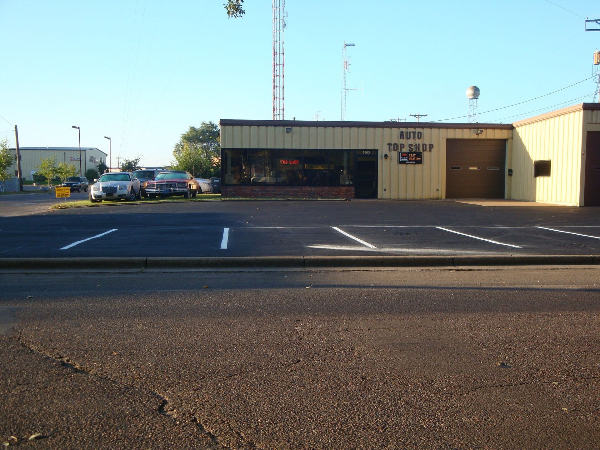 Parking lot in front of a tan building with