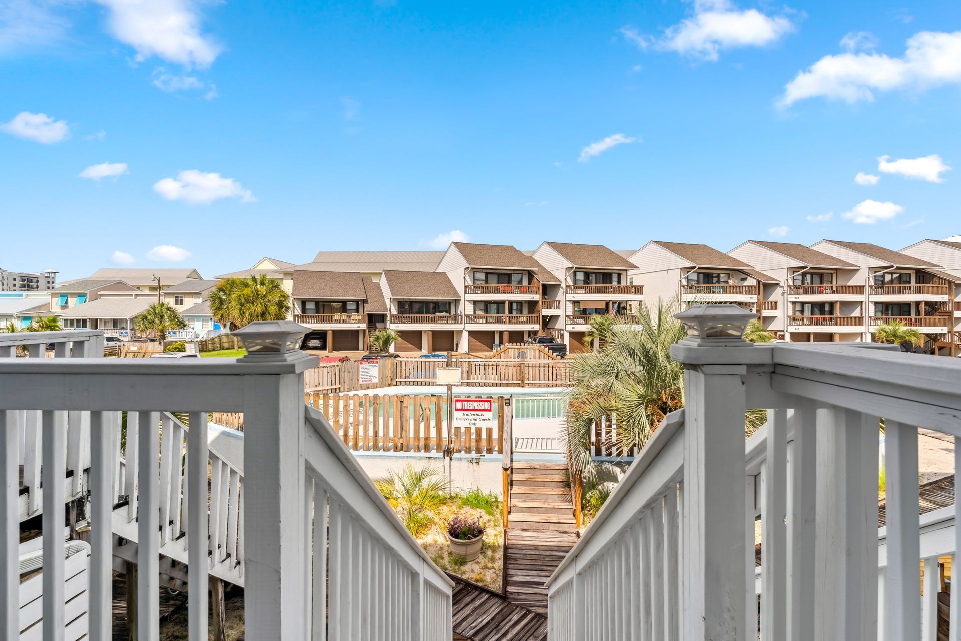 A view of a city from a balcony with stairs leading up to it.