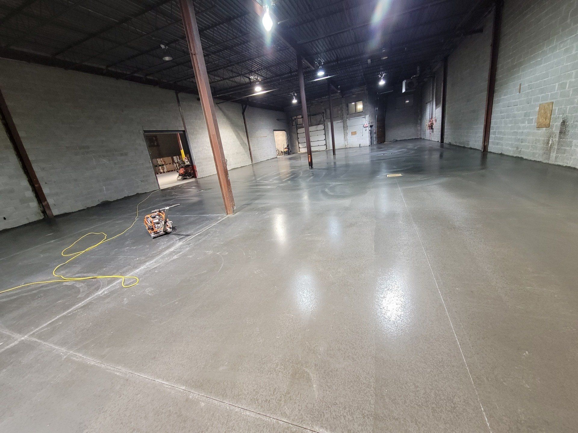 A large empty warehouse with a concrete floor.