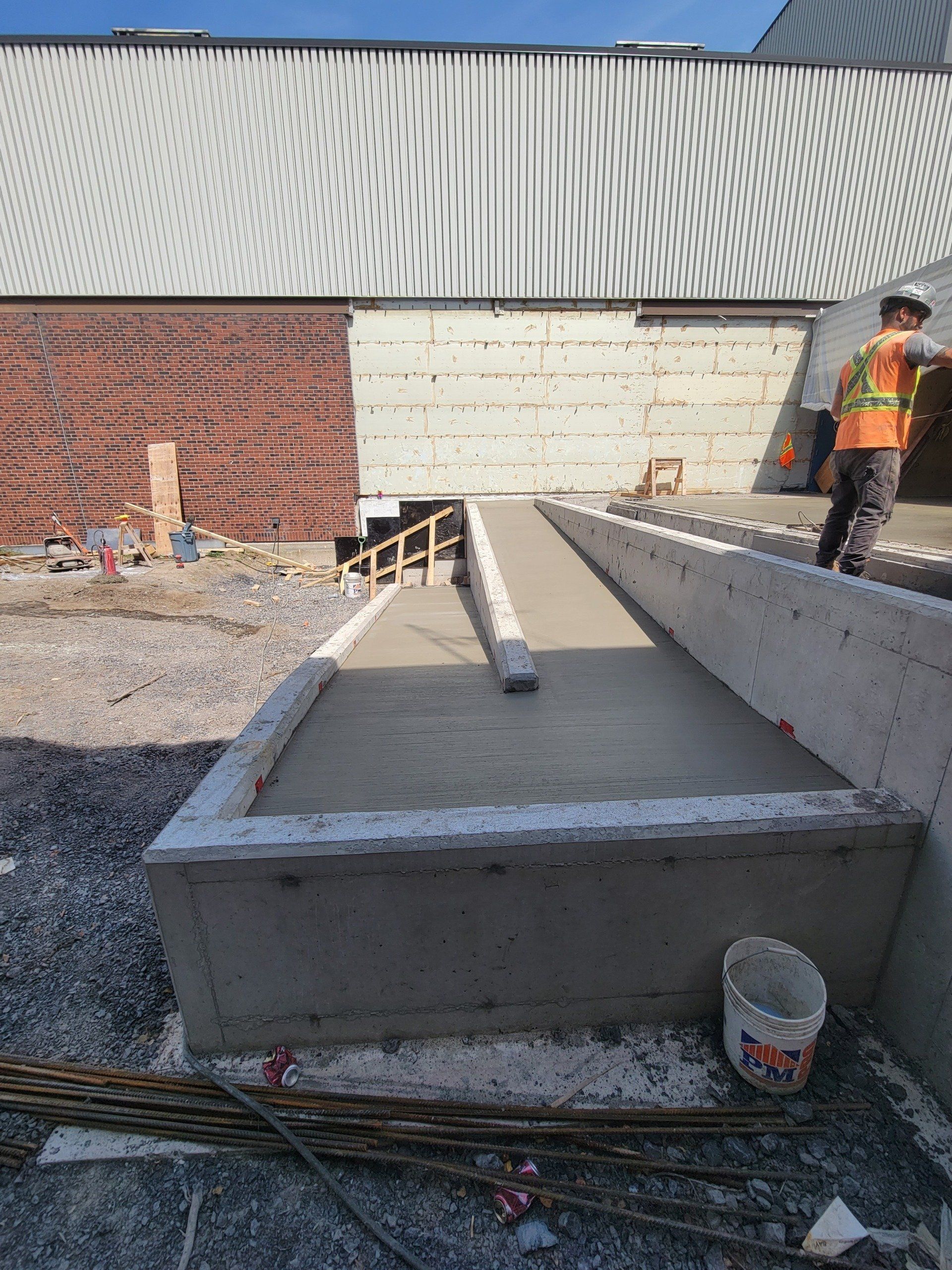 A concrete ramp is being built in front of a building.
