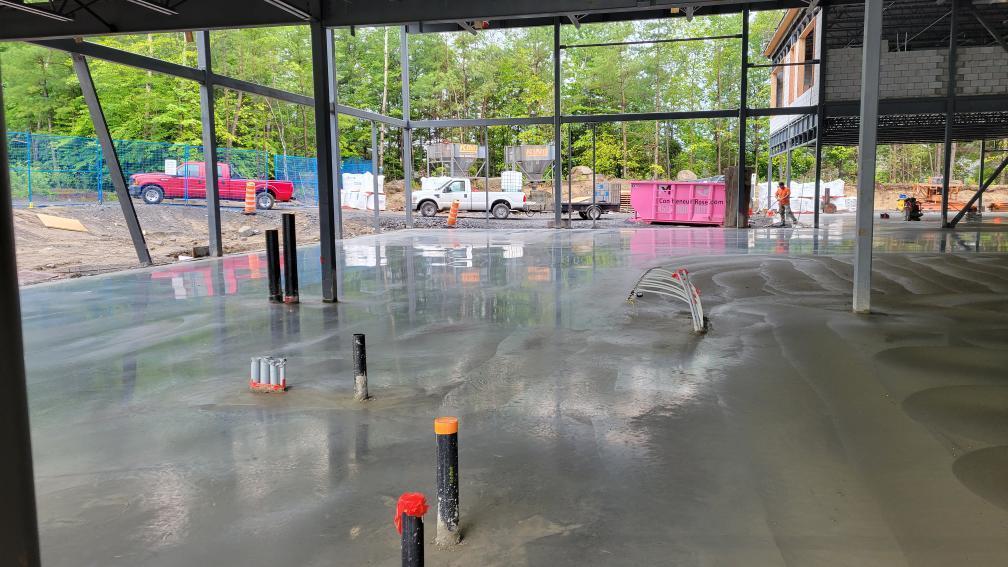 A large concrete floor in a building under construction.