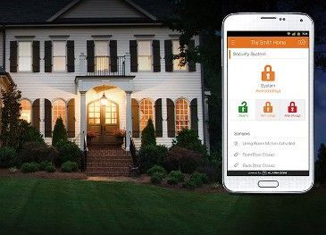 A smart phone is sitting in front of a house.