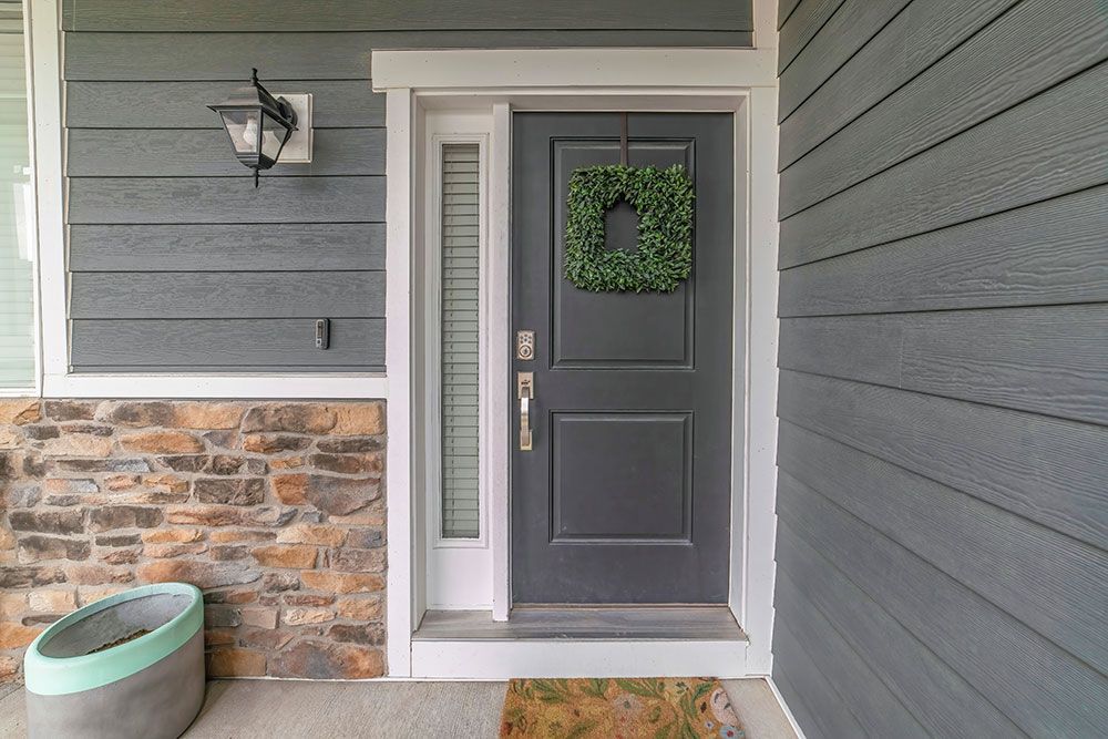 The front door of a house with a wreath on it.