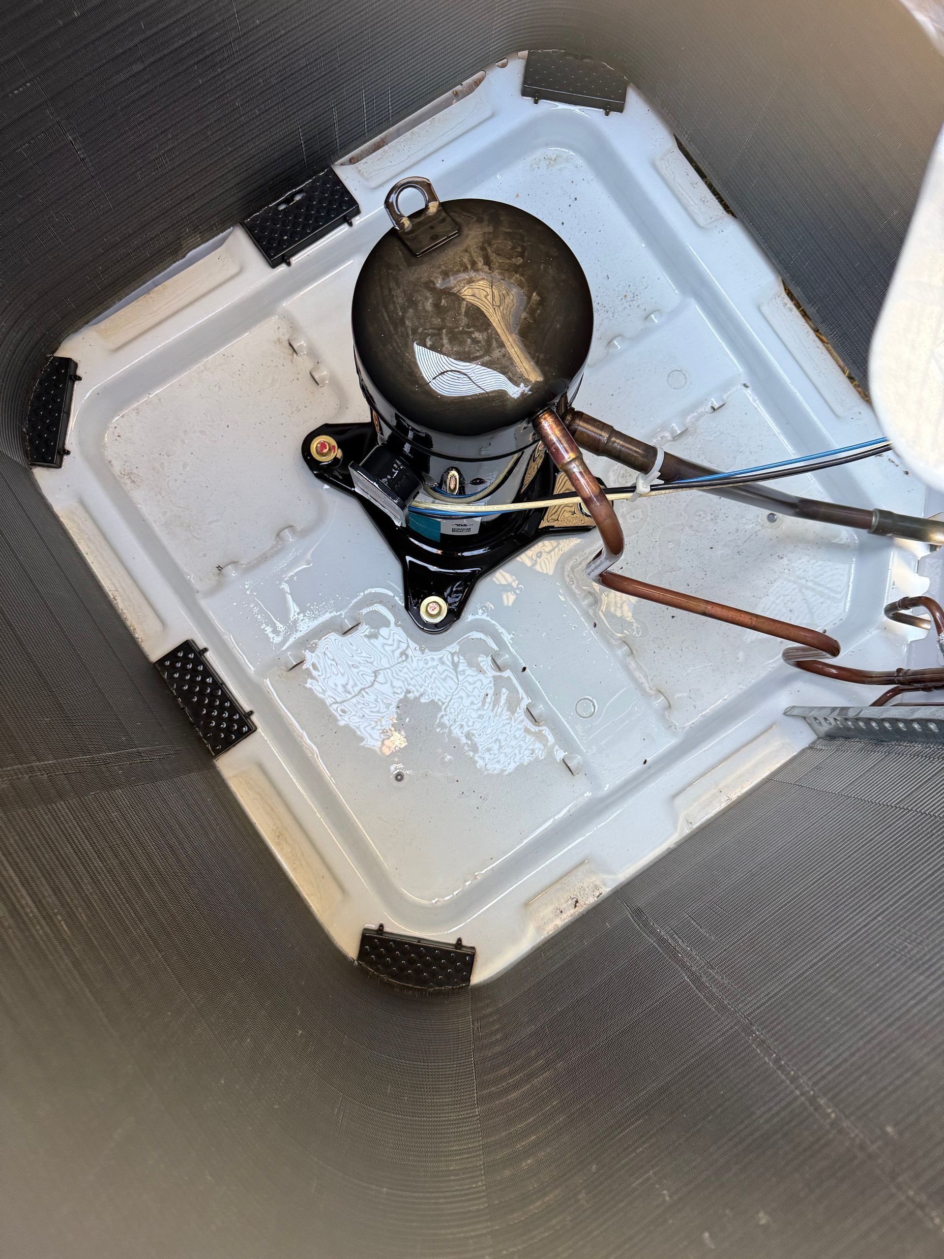 AC system electrical component being inspected during tune-up