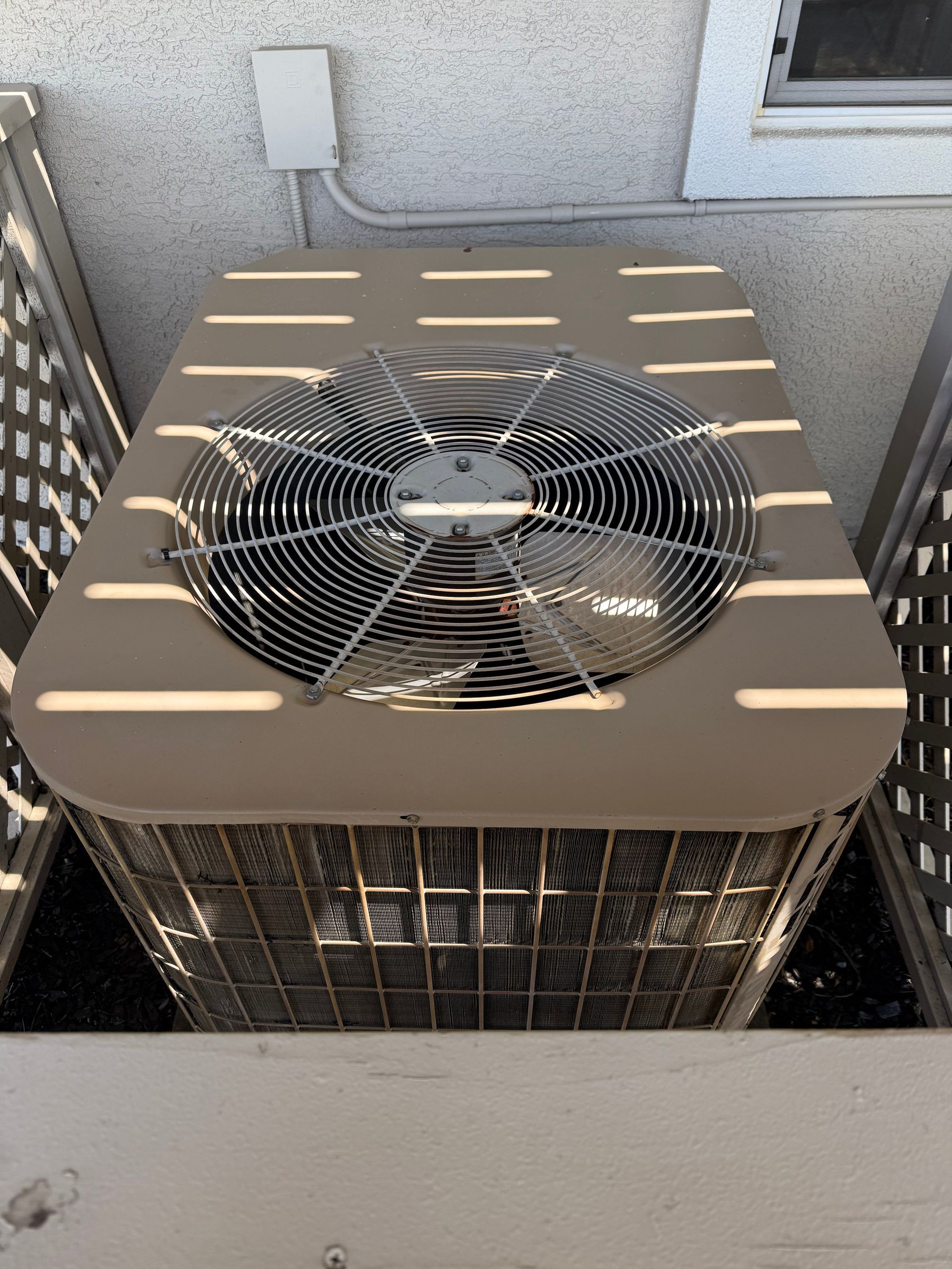Older central AC outdoor condenser unit in Folsom before service