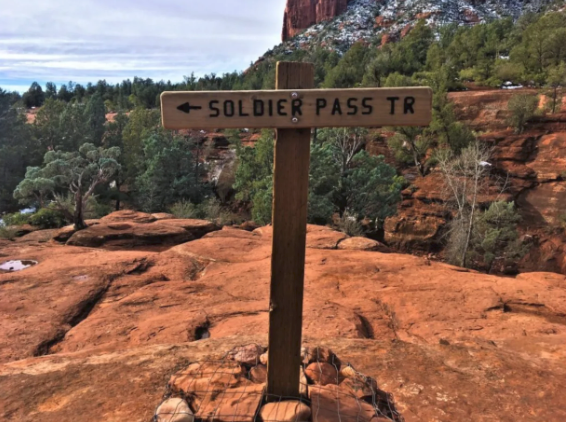 A wooden sign that says soldier pass tr on it