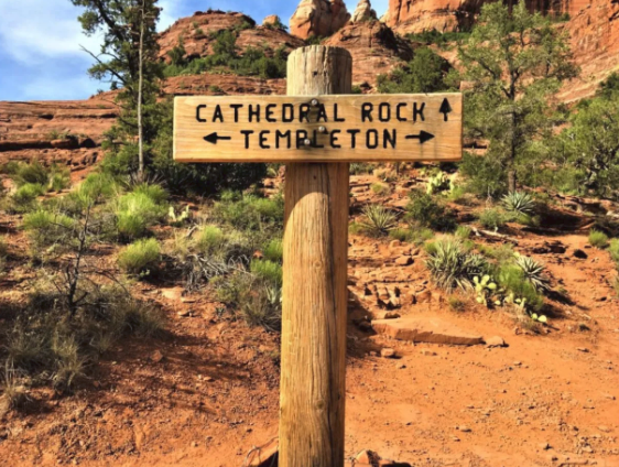 A wooden sign points the way to cathedral rock and templeton