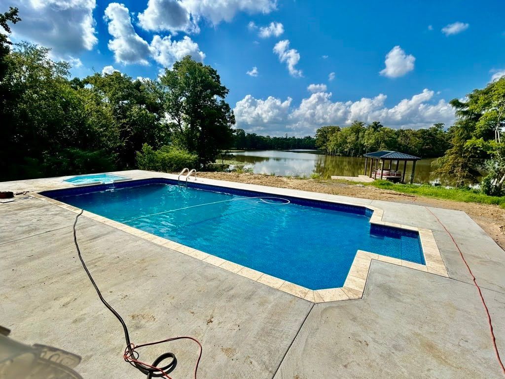 A large swimming pool with a gazebo in the background