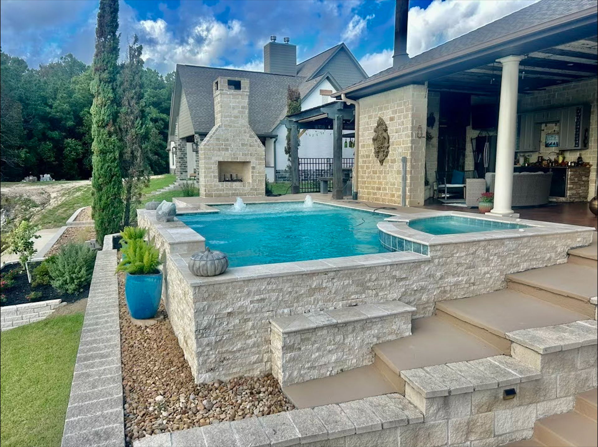 A large swimming pool is in the backyard of a house.