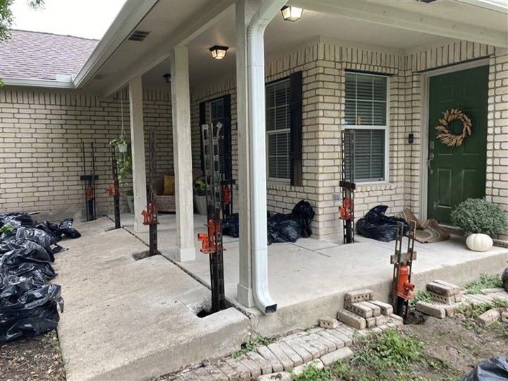 Foundation Inspections photo showing a detailed process on a brick home porch, utilizing specialized equipment for accurate assessment and preparation for Foundation Repair Solutions. Foundation Inspections photo showing a detailed process on a brick home porch, utilizing specialized equipment for accurate assessment and preparation for Foundation Repair Solutions.