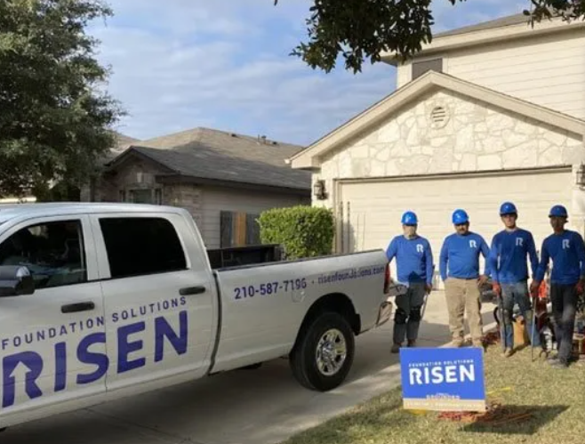 A group of men standing beside white truck