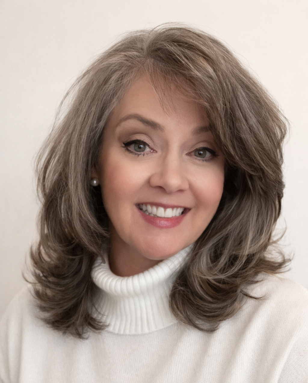 A man in a suit and white shirt is smiling for the camera.