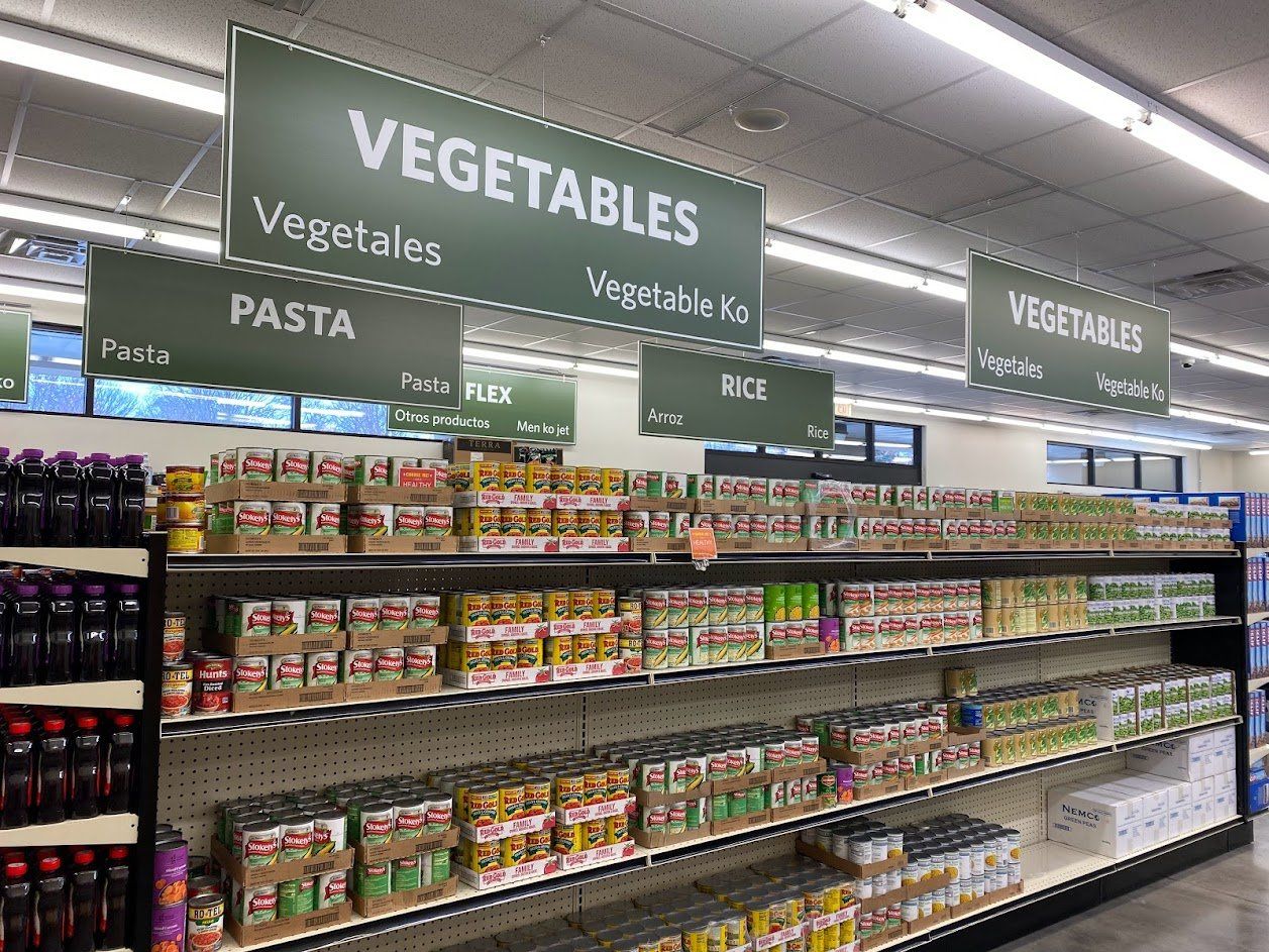 A grocery store aisle filled with vegetables and pasta.