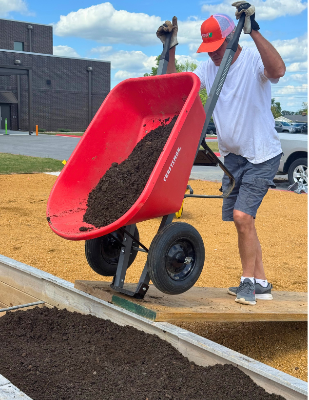 A row of wooden sheds sitting next to each other in a garden.