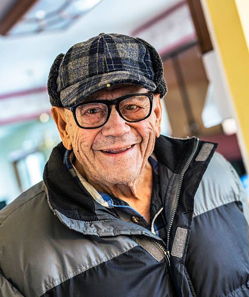 A woman is holding a white plate with a pizza on it