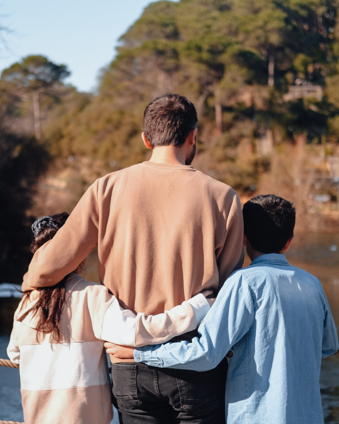 A woman is holding a white plate with a pizza on it
