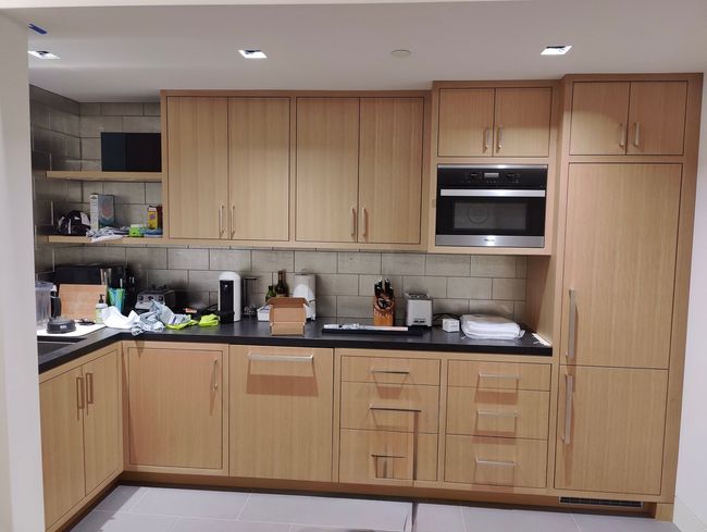 Modern kitchen with light wood cabinets and stainless steel appliances