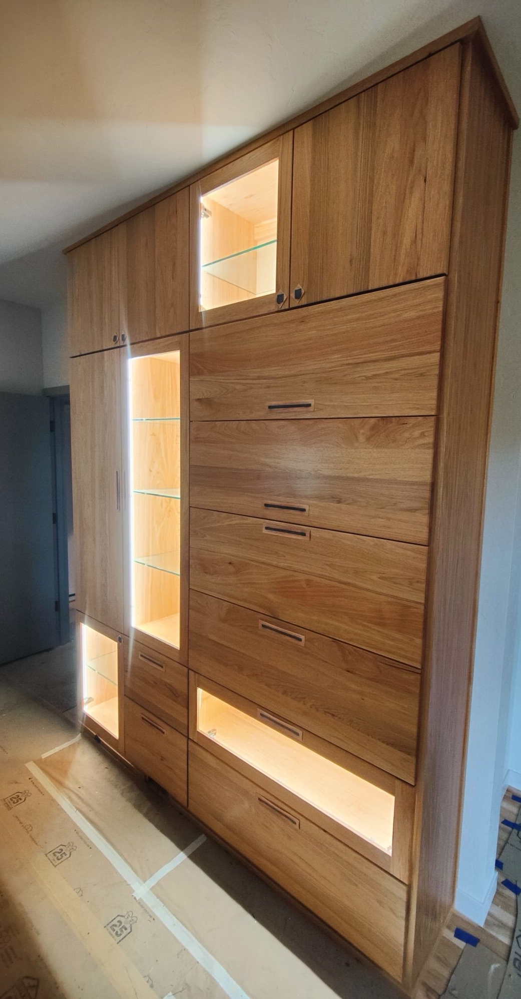 Built-in white storage cabinets in an attic, utilizing sloped ceiling space