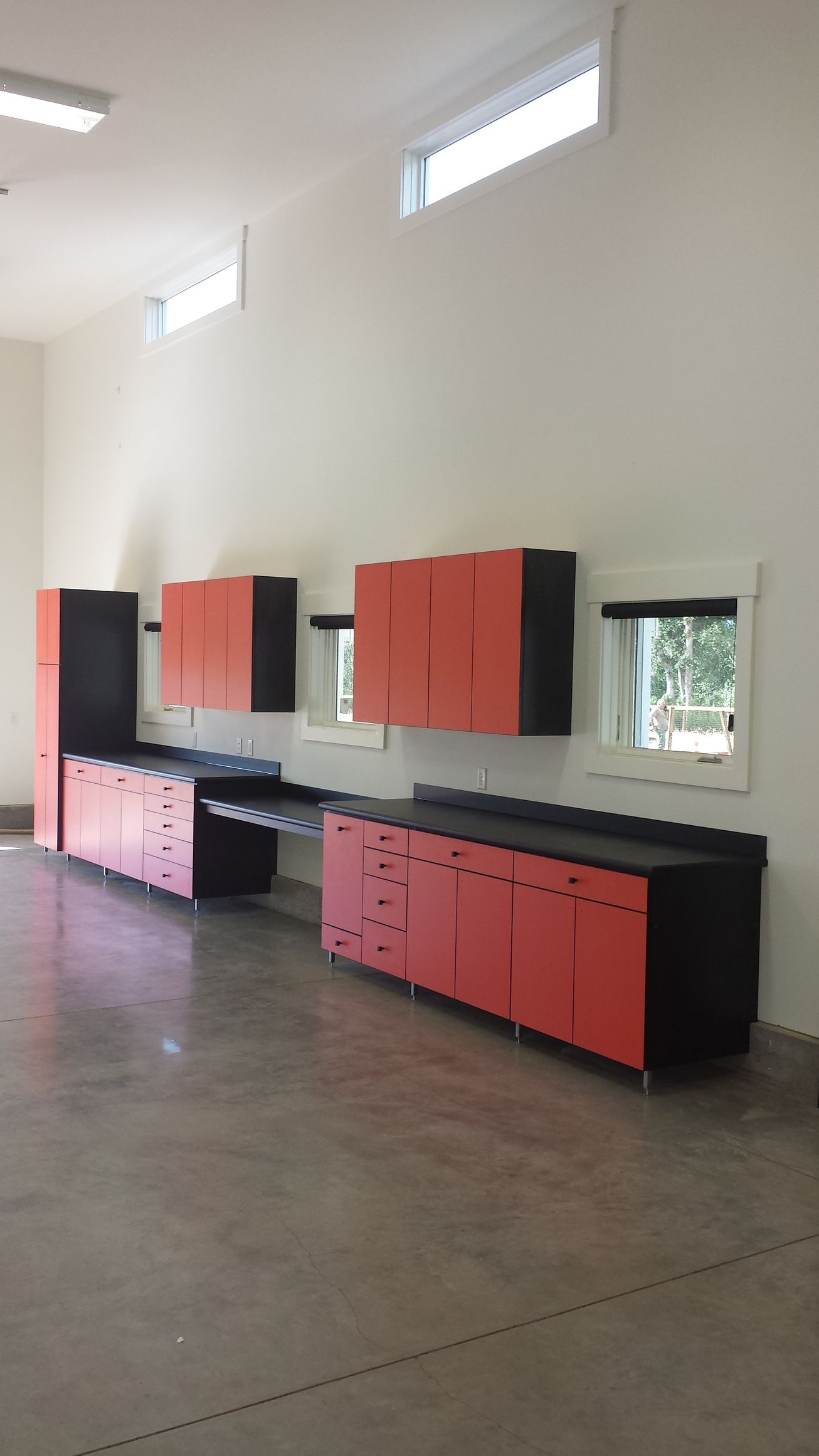 Garage with wood cabinets and a wooden workbench