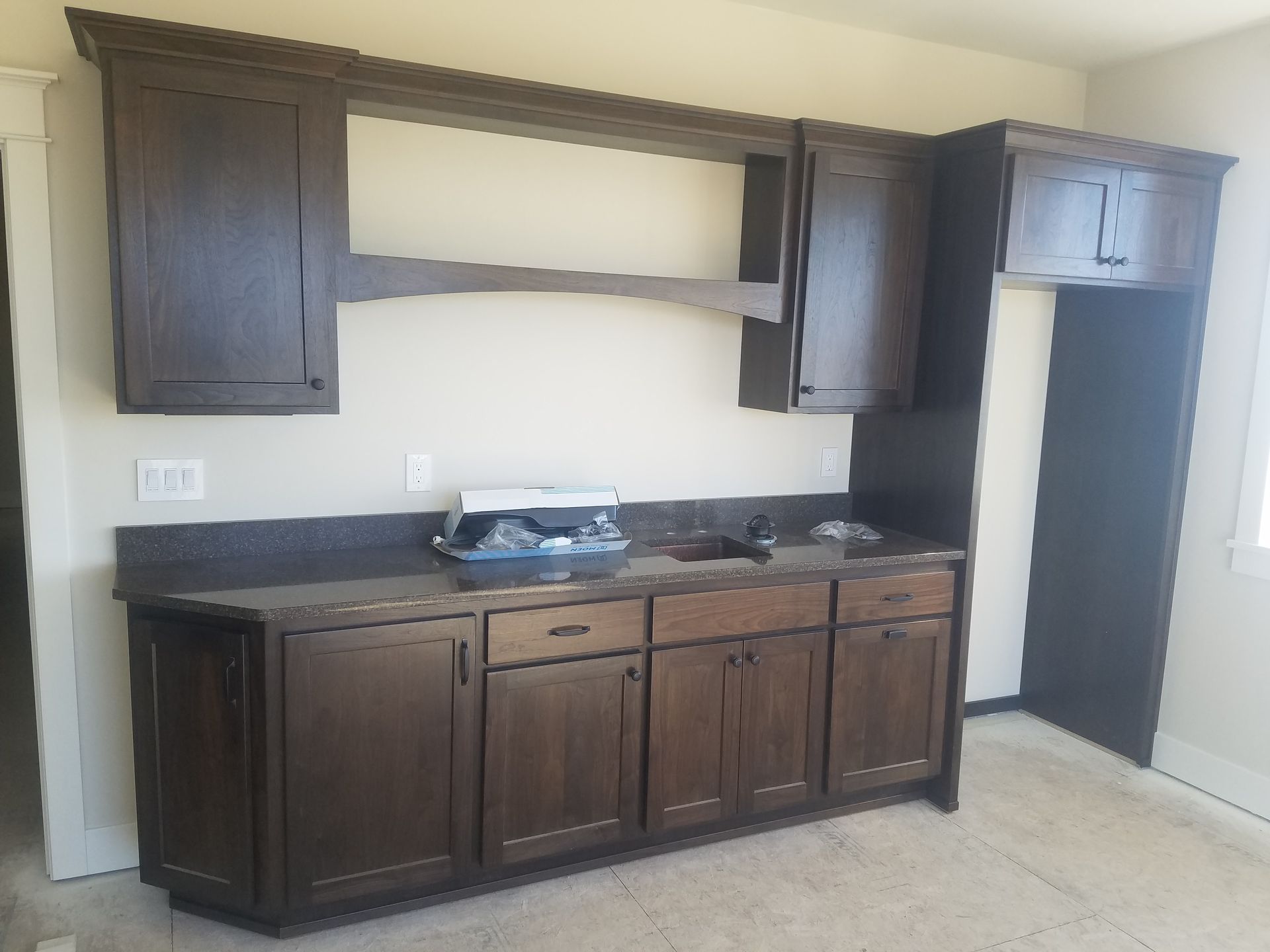 Wooden staircase with built-in drawers. Door is visible on the left side