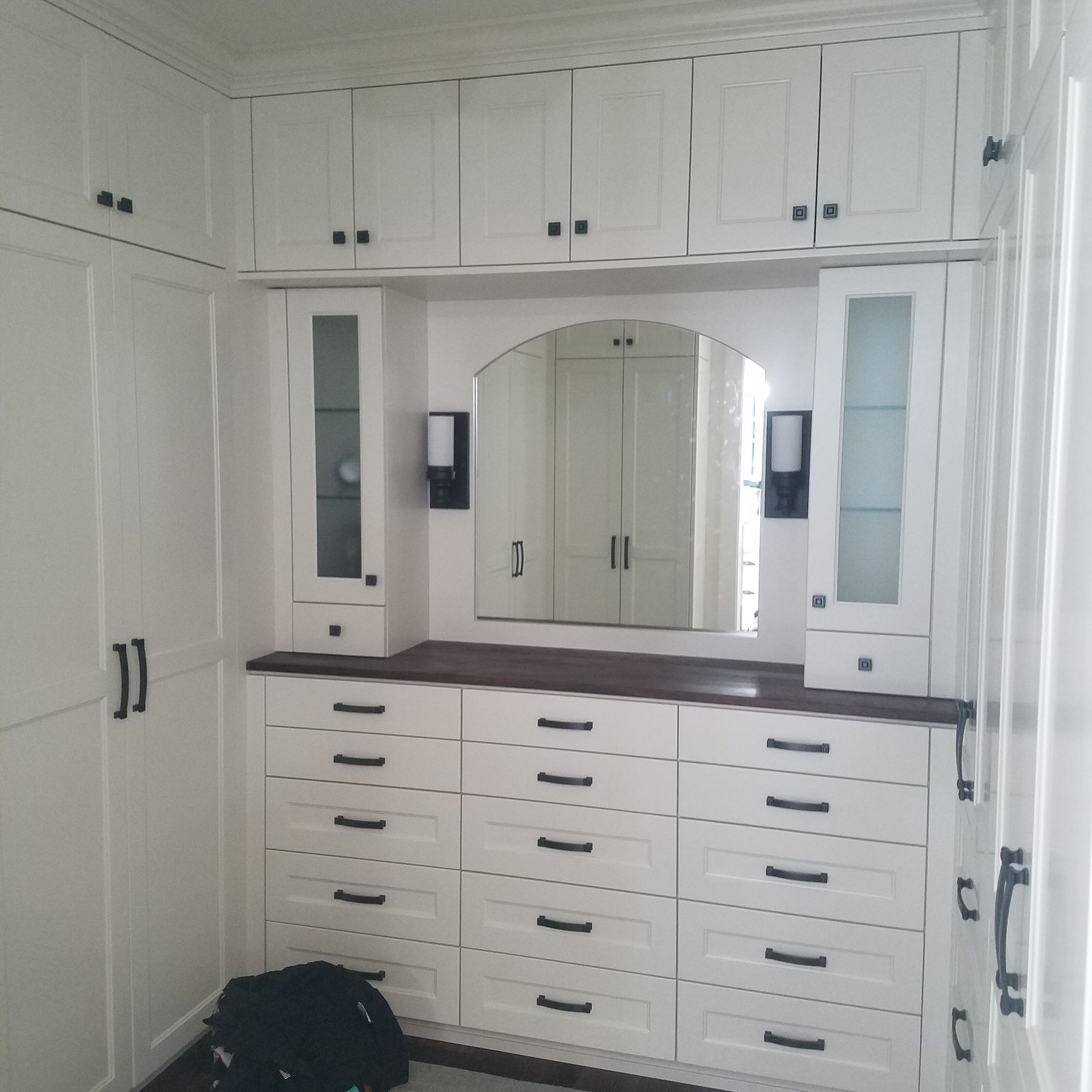 Walk-in closet with built-in wooden shelving for clothes