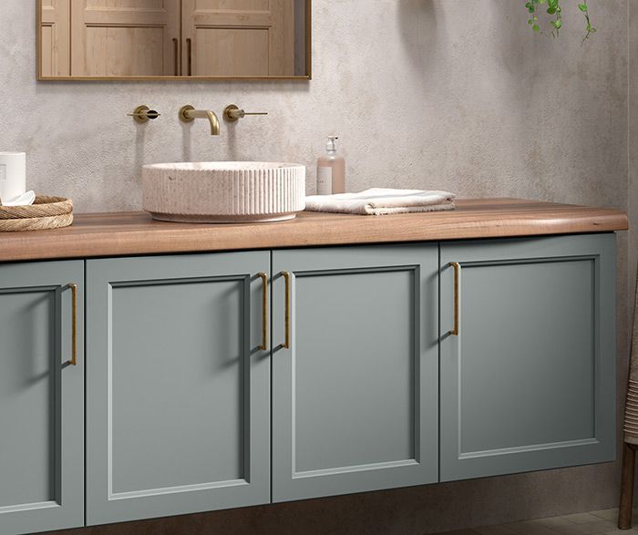 Bathroom vanity with gray cabinets, wood countertop, stone sink, and gold hardware. Bathroom vanity with gray cabinets, wood countertop, stone sink, and gold hardware.