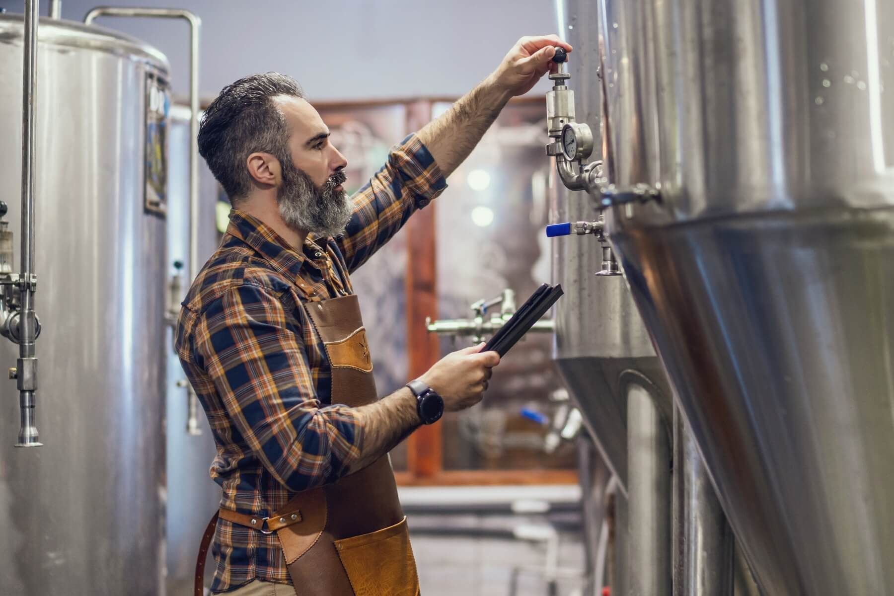 A man is working in a brewery