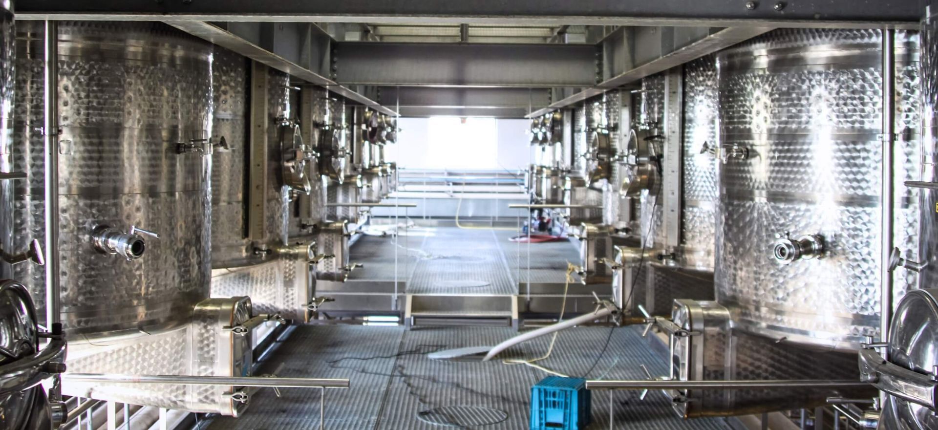 A large room filled with lots of stainless steel tanks